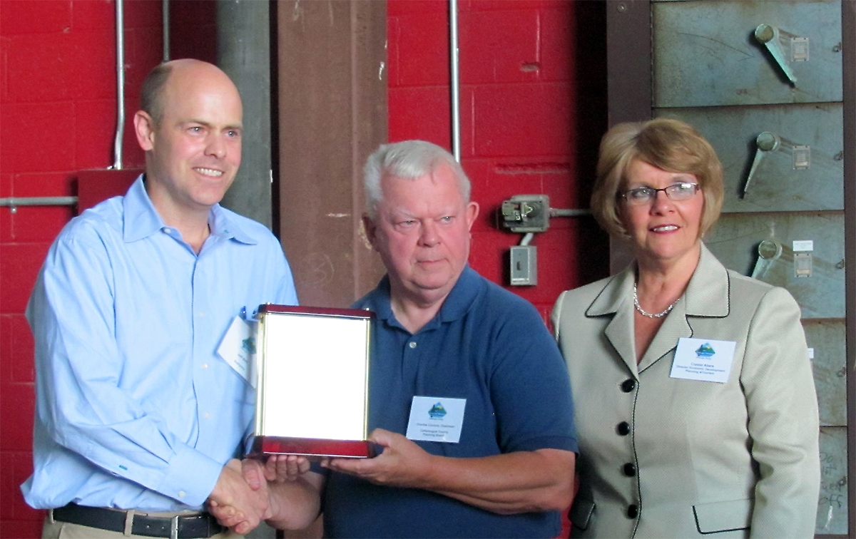 (l to r): Jeff Belt receives the Brooks Patterson Community Leadership Award from Charles Couture, Chairman of the Cattaraugus County Planning Board and Crystal Abers, Director, Cattaraugus County Department of Economic Development, Planning and Tourism. Photo by CCEDPT. Jeff Belt receives the 2012 Brooks Patterson Community Leadership Award