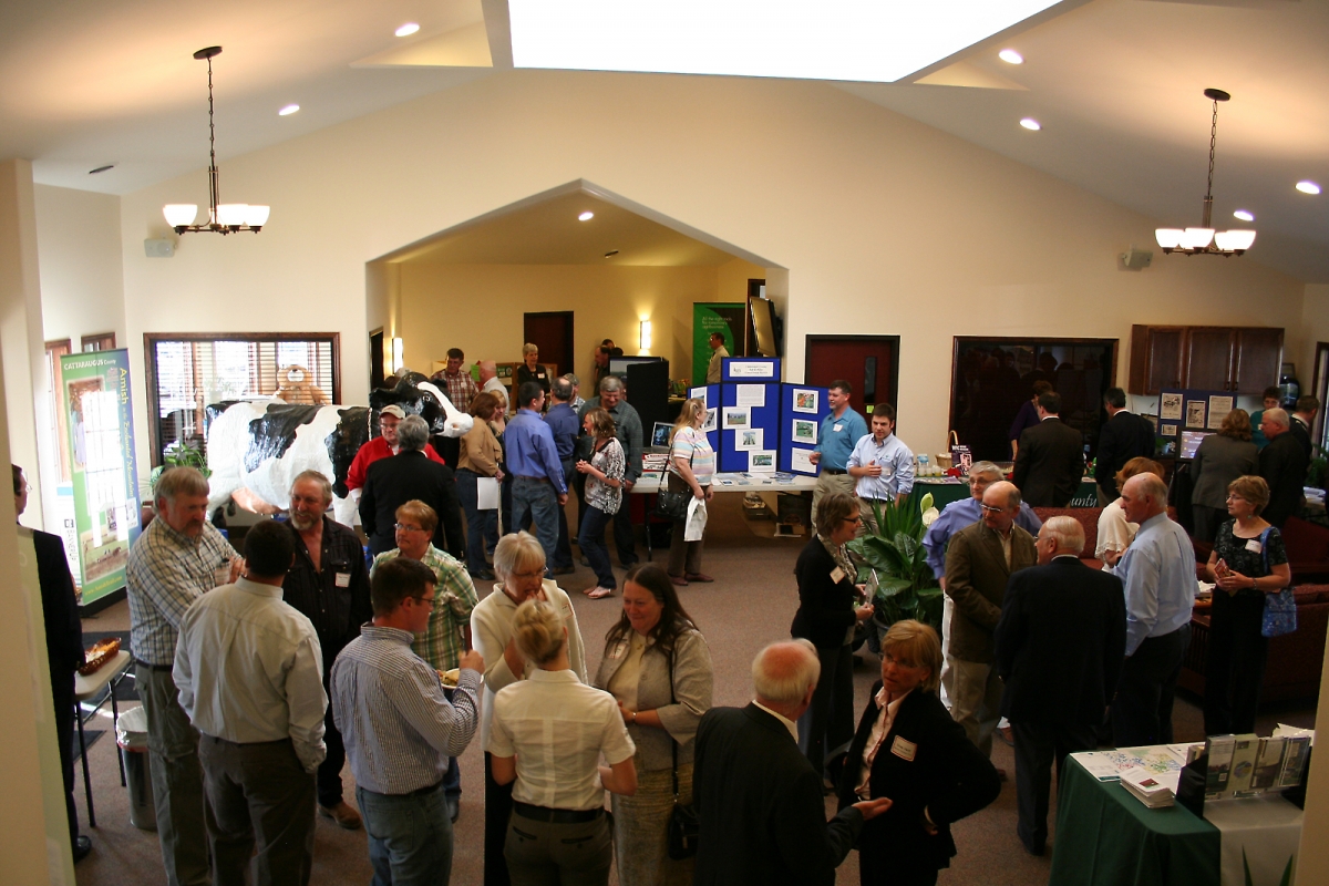 People gathering and visiting displays at the 2012 Farmer-Neighbor Dinner.