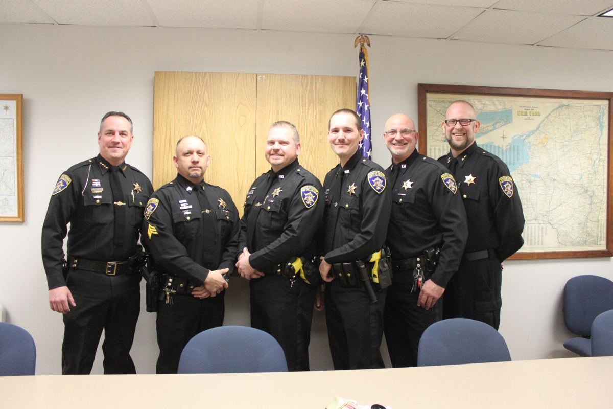 Photo from left to right: Sheriff Timothy Whitcomb, Sergeant Andrew Rozler, Deputy Hanz Heineman, Deputy Steven Dombek, Captain Shawn Gregory and Undersheriff Eric Butler Catt. Co. Sheriff, three Deputy Sheriffs, Captain and Undersheriff