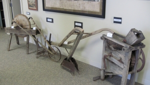 sharpening wheel, push tiller, plow and corn grinder dating back to 1809