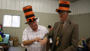 Cattaraugus County Legislators holding a woolybear caterpillar