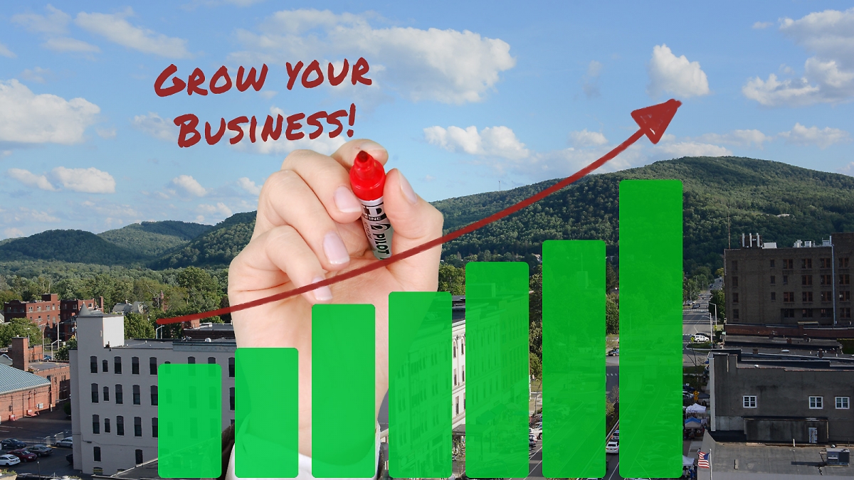 Grow your business! Chart with hand writing, overlayed on picture of Olean, NY
